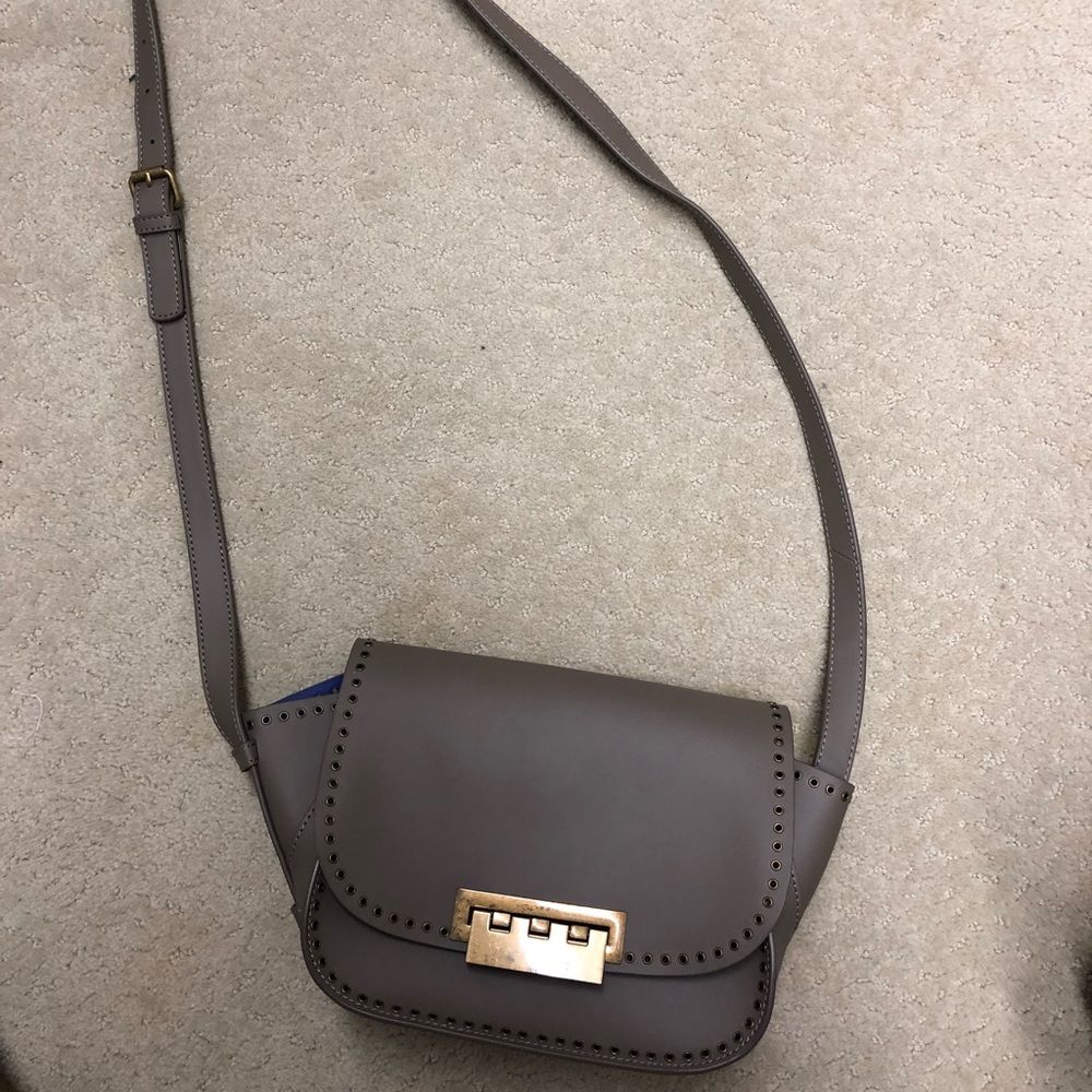 Taupe crossbody bag with grommet detail